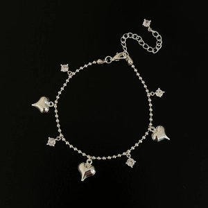 Elegant silver heart bracelet with sparkling zircon stones on a sleek black background