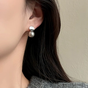 Elegant silver stud earrings featuring a polished metal disc and a large grey pearl drop