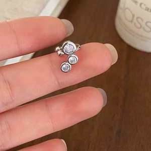 Elegant silver ear cuff featuring three sparkling cubic zirconia on a minimalist band