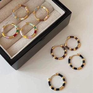 French retro contrast color enamel hoop earrings in various elegant colors on a jewelry box