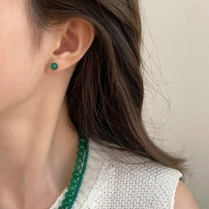 Retro style green chalcedony stud earrings and matching beaded necklace on model