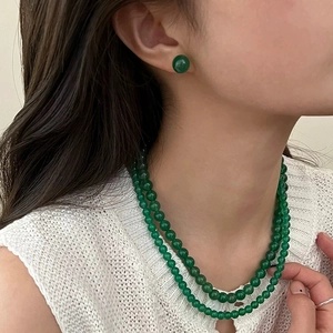Detail of elegant green chalcedony bead earrings and matching double-layer necklace set