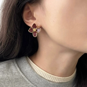 Elegant four-leaf flower stud earrings in deep red enamel and gold-plated finish
