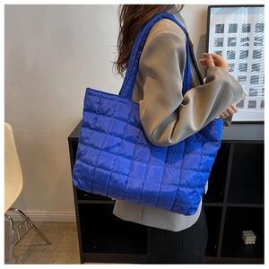 Quilted blue down tote bag with spacious design for daily commute and shoulder carry