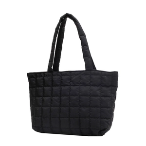 Black quilted puffer tote bag with a minimalist design and soft nylon padded handles