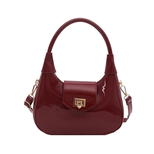 Deep red patent leather hobo handbag with a sleek golden turn-lock closure and handle