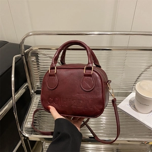 Vintage burgundy shell handbag with leather texture and embossed COIH 2DN branding