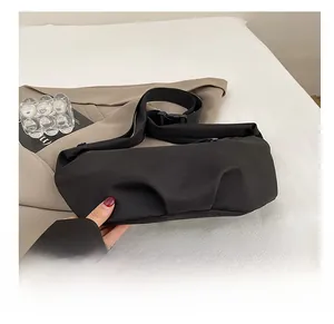 Detail of the durable reinforced base on a minimalist black canvas crossbody dumpling bag