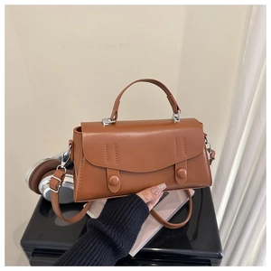 Close-up of brown faux leather mini square bag featuring silver hardware and a top handle