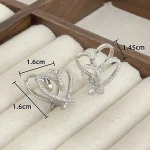 Detail of silver heart earrings with white cubic zirconia inlay on jewelry box