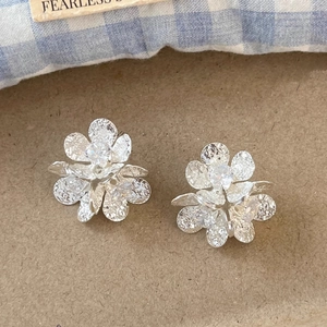 Elegant zircon flower stud earrings with textured petals and silver metal finish