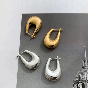 Minimalist U-shaped hoop earrings in polished gold and silver metal finishes