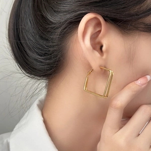 Minimalist double layered square geometric gold earrings for women shown on model