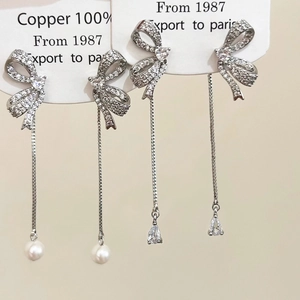 Elegant bow tassel earrings with pearls and zircon crystals in polished copper silver finish