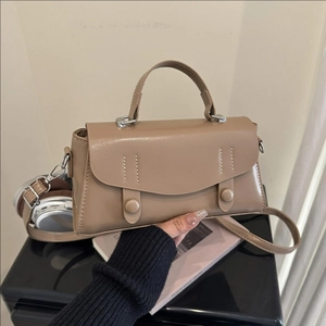 Classic khaki faux leather crossbody handbag for women featuring a top handle and shoulder strap