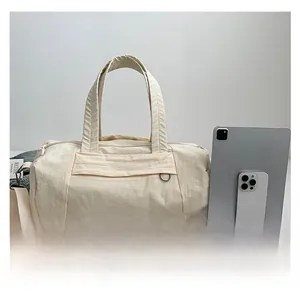 Detail of cream nylon travel bag showing large capacity with tablet and phone for scale