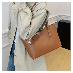 Brown faux leather tote bag with printed silk scarf and adjustable gold-tone buckles