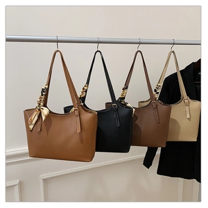 Detail view of large PU leather tote bags in four colors with silk scarf handles