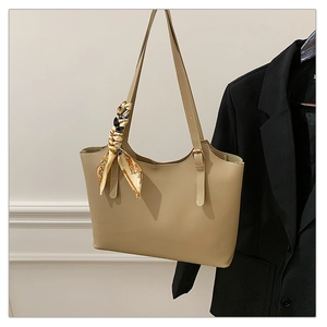 Detail view of khaki tote bag with vintage printed silk scarf on high quality leather
