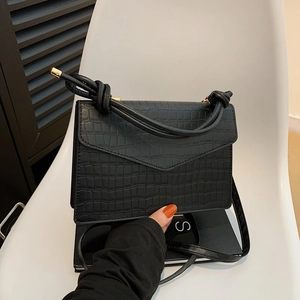 Elegant black stone pattern shoulder bag with knotted handle and golden hardware details