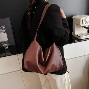 Chic burgundy faux leather tote bag with wide strap, urban minimalist crossbody style