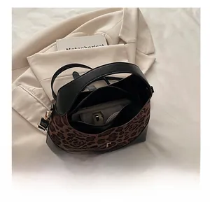 Leopard print and black leather handbag interior showcasing spacious storage and zip pocket