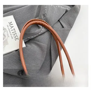 Detail eines braunen Ledergriffs mit sauberer Naht an einer Vintage-Tasche