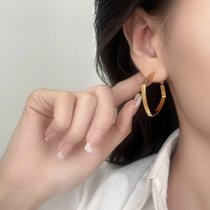 Minimalist gold geometric irregular pentagon hoop earrings with a textured matte finish