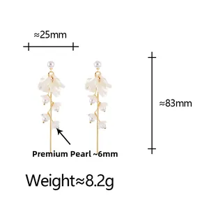Detail view of pearl petal tassel earrings with measurements of 83mm length and 25mm width