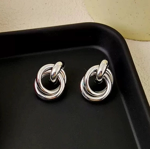 Minimalist silver interlocking triple hoop earrings with a polished geometric finish