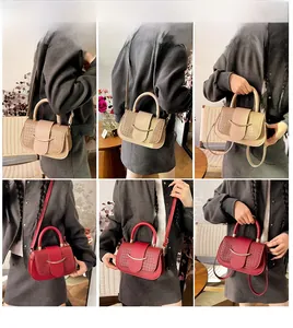 Detailed views of crossbody square bag showing beige and red textured leather finishes