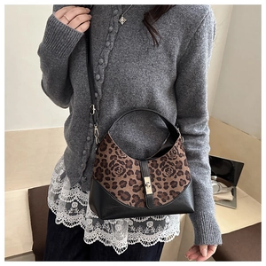 Detail of vintage leopard rose print handbag with gold twist lock and black leather trim