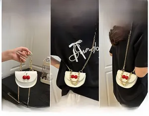 Versatile mini white crossbody bag with cherry detail shown in three carrying styles