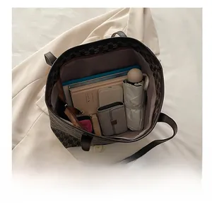 Detail view of large PU tote bag interior showing ample storage for a tablet and umbrella
