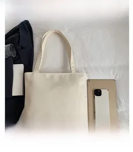 Detail view of the beige tote bag interior capacity with iPad and everyday essentials