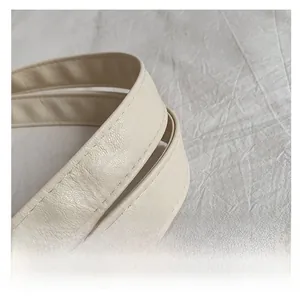 Detail of the thick cream faux leather handle with premium stitching on a tote bag