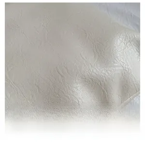 Close-up of off-white faux leather fabric with premium lychee grain and soft texture