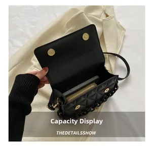 Interior capacity detail showing black quilted handbag with phone and gold wallet inside
