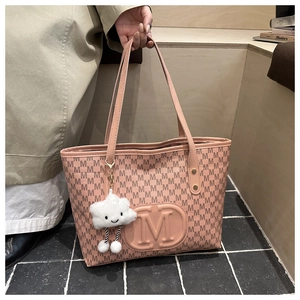Detail of pink tote bag with M monogram print and a cute white cloud plush pendant