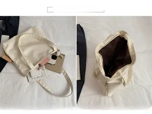 Detail view of large beige tote bag showing spacious interior for tablets and daily items