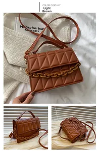 Close-up of light brown crossbody bag featuring triangle quilting and resin chain detail