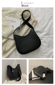 Vue détaillée du sac demi-lune noir minimaliste avec boucles argentées et fini mat