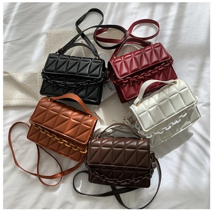 Group display of geometric quilted shoulder bags in five colors with thick chain decor