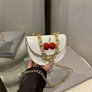 Minimalist white half-moon crossbody bag with red rhinestone cherry motif and gold chain