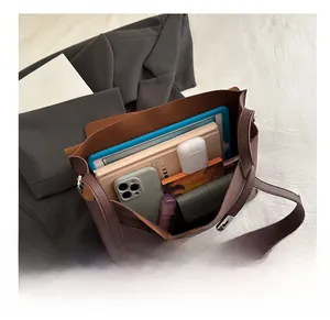 Spacious interior of a brown PU leather crossbody bag showing its large storage capacity