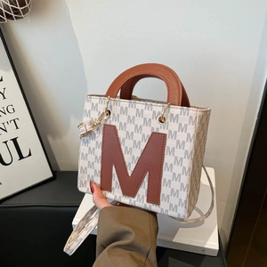 Minimalist tote bag with M-letter pattern and brown leather accents for women
