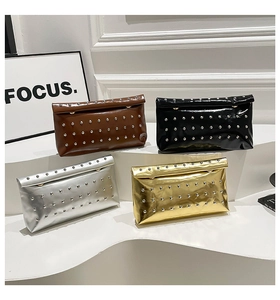 Detail of studded clutch bags in brown, black, silver and gold with metallic rivets
