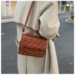 Caramel quilted crossbody bag with resin chain detail and adjustable strap for women
