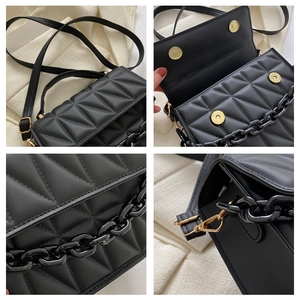 Fashionable black quilted crossbody bag with resin chain and adjustable leather strap
