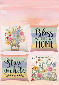 Close-up of four floral spring cushion covers with decorative text on wood background